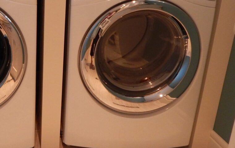 Front-loading tumble dryer in a laundry room